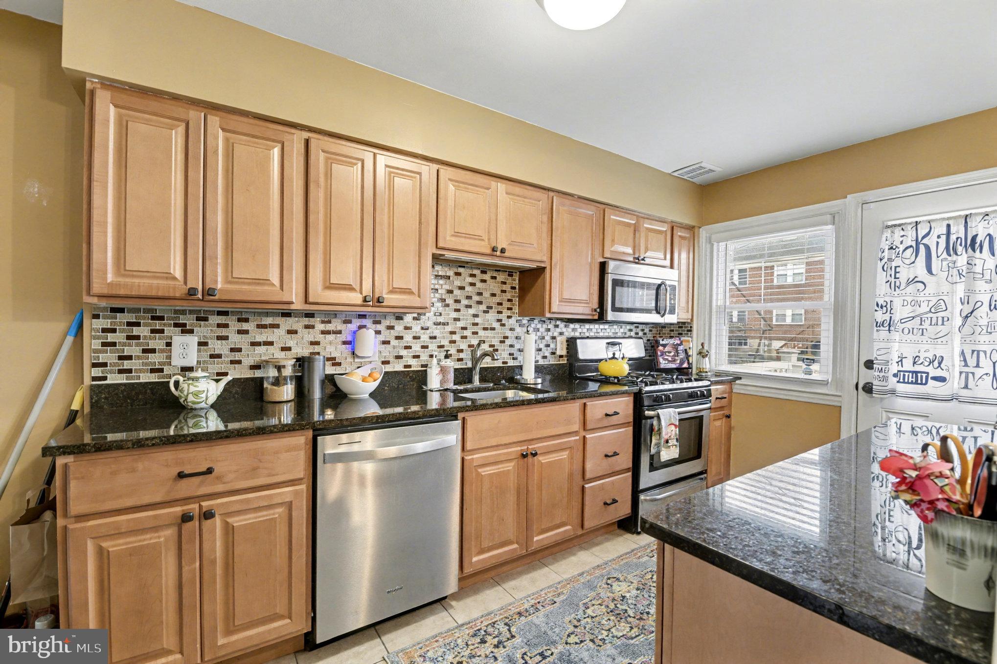 1510 Medford Road Baltimore, MD 21218 - Photo 10 of 30 a kitchen with granite countertop a sink stainless steel appliances and cabinets