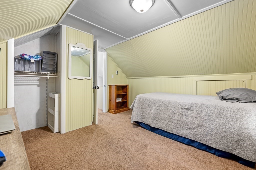 5 Colonial Drive Leicester, MA 01611 - Photo 19 of 24 a bedroom with a bed and a refrigerator