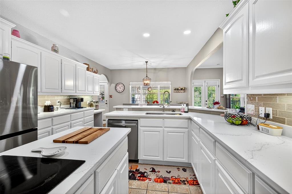202 Hillside Lindsay, TX 76250 - Photo 12 of 37 a kitchen with a sink a stove a refrigerator and cabinets