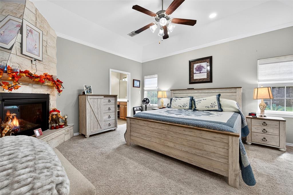 202 Hillside Lindsay, TX 76250 - Photo 19 of 37 a bedroom with bed and a chandelier