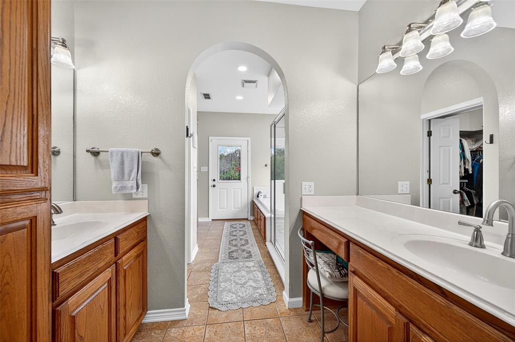 202 Hillside Lindsay, TX 76250 - Photo 21 of 37 a bathroom with a sink double vanity granite and a mirror