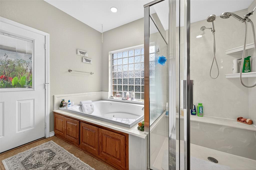 202 Hillside Lindsay, TX 76250 - Photo 22 of 37 a bath room with a bath tub and a shower