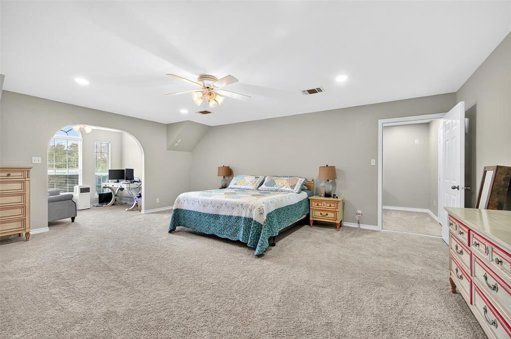 202 Hillside Lindsay, TX 76250 - Photo 26 of 37 a spacious bedroom with a bed and a chandelier
