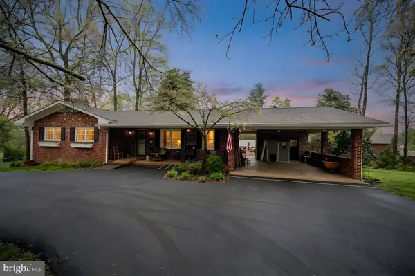 a view of a house with a yard and sitting area