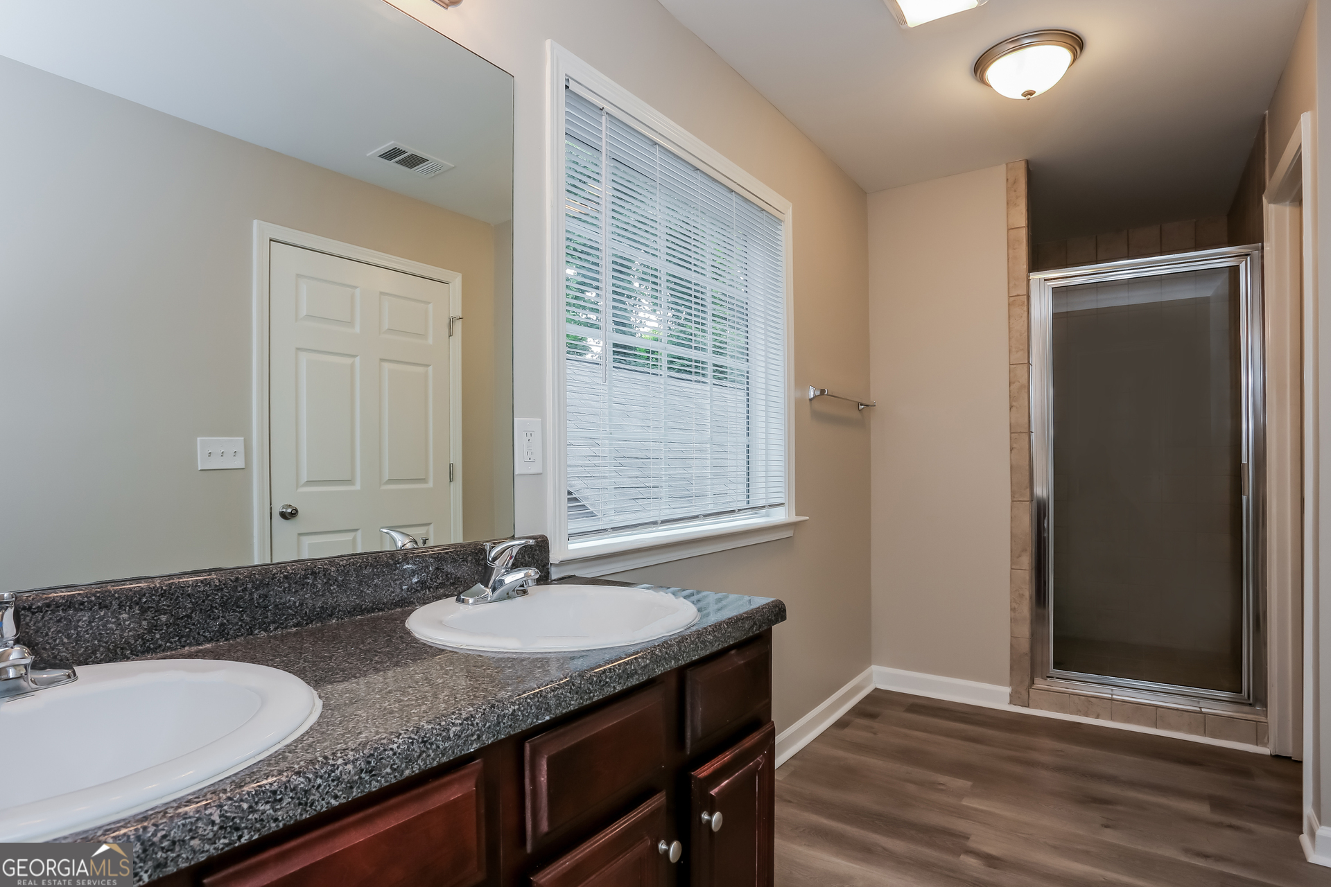 2041 Pryor Road Southwest Atlanta, GA 30315 - Photo 12 of 17 a bathroom with a granite countertop sink and a mirror