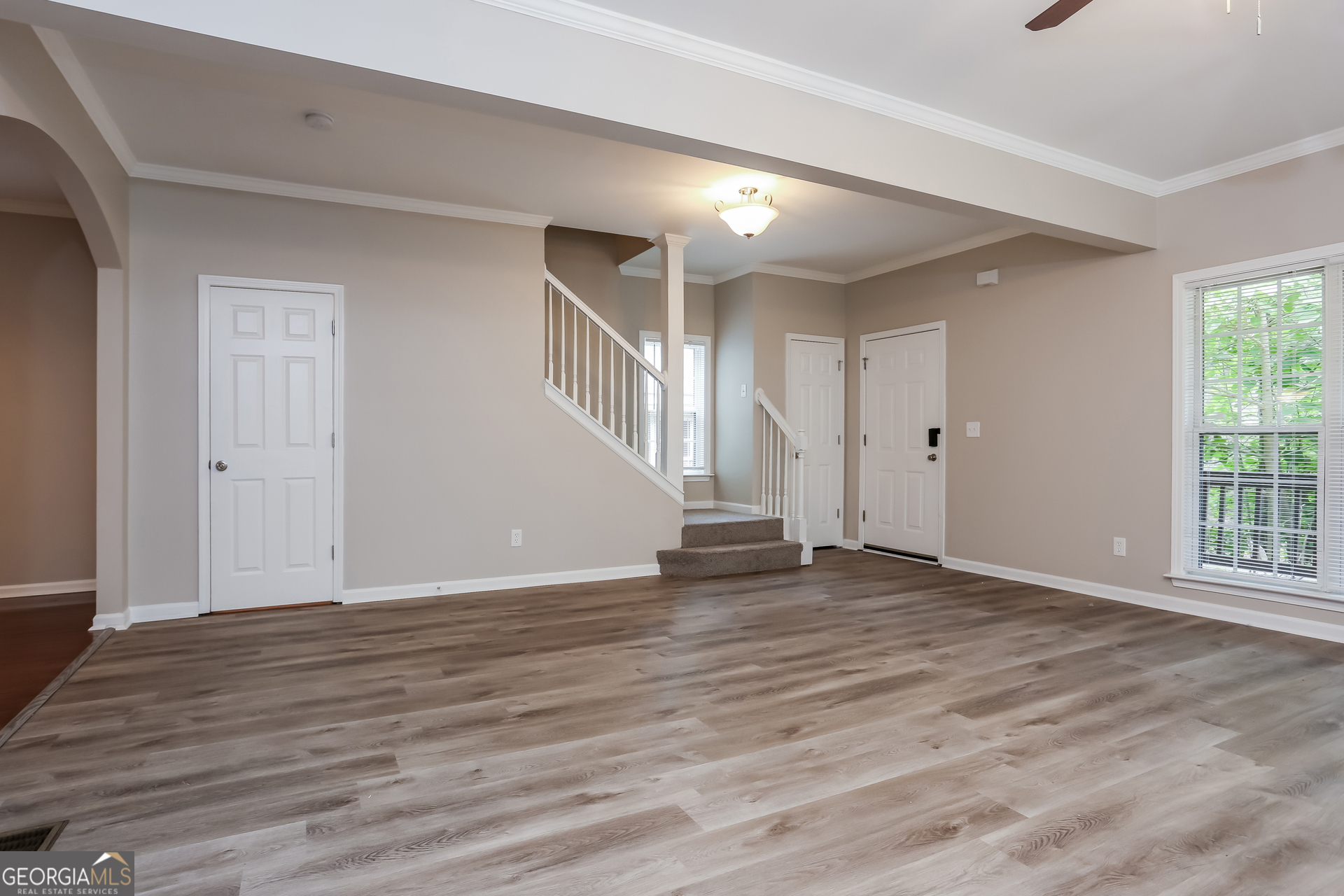 2041 Pryor Road Southwest Atlanta, GA 30315 - Photo 4 of 17 a view of an empty room with wooden floor and a window