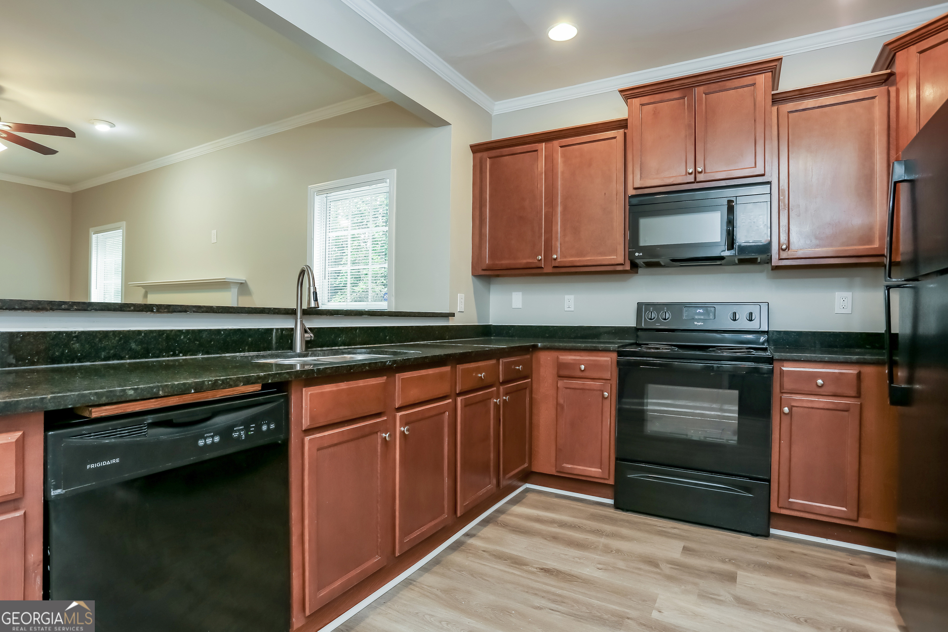 2041 Pryor Road Southwest Atlanta, GA 30315 - Photo 6 of 17 a kitchen with stainless steel appliances granite countertop a sink stove and microwave