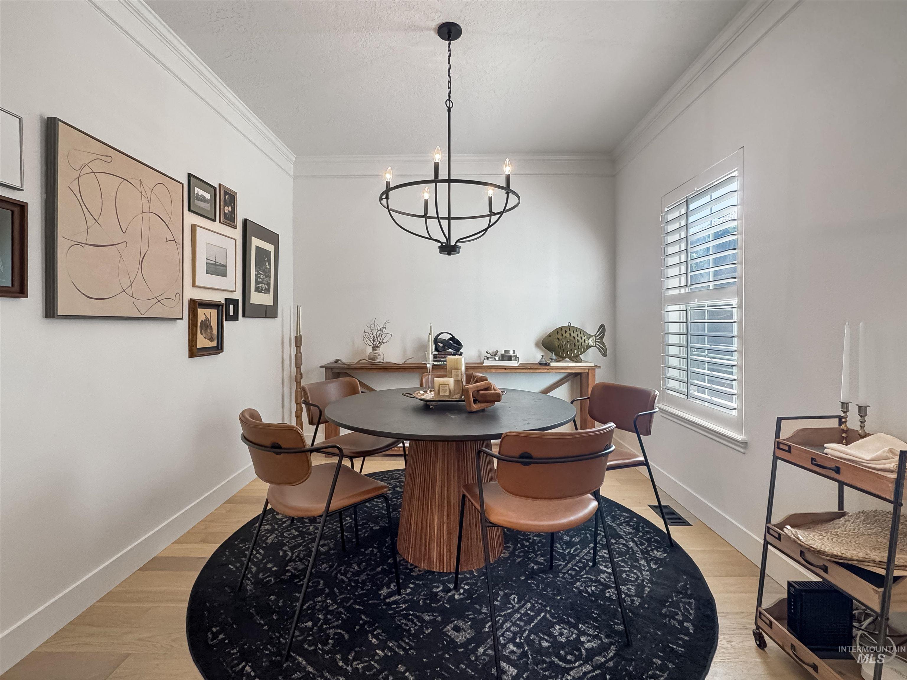 3917 North Waterloo Way Boise, ID 83713 - Photo 10 of 24 Crown molding details, wood-finish flooring, and a window with plantation shutters