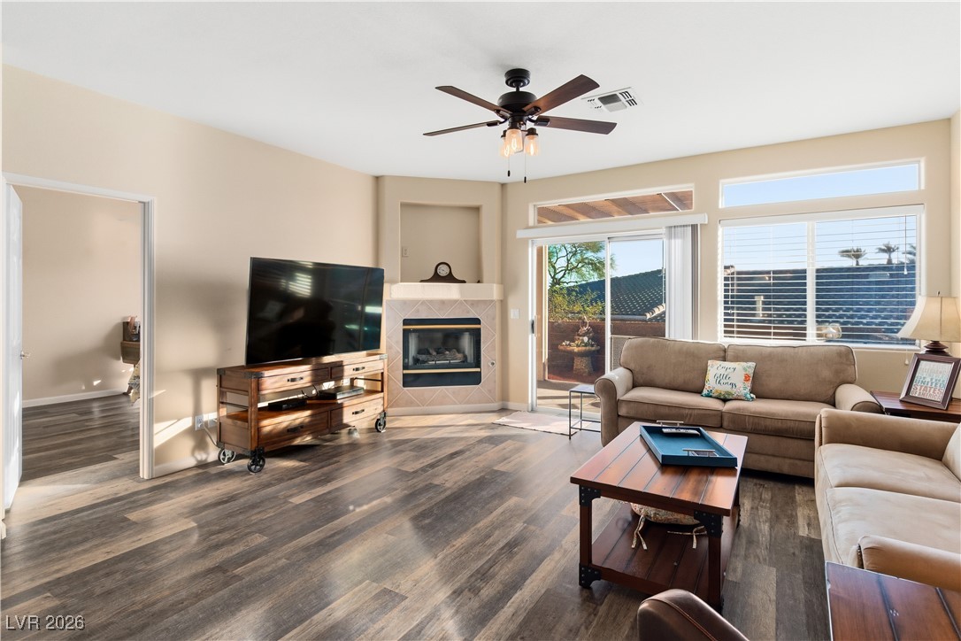 3350 Pheasant Canyon Way, Unit 1008 Laughlin, NV 89029 - Photo 13 of 80 Living area featuring a tile fireplace, ceiling fan, and dark wood finished floors