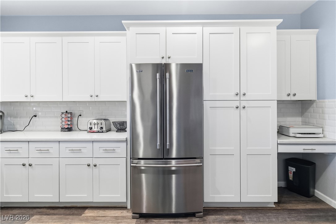 3350 Pheasant Canyon Way, Unit 1008 Laughlin, NV 89029 - Photo 16 of 80 Kitchen featuring backsplash, high end refrigerator, white cabinetry, and dark wood-style floors