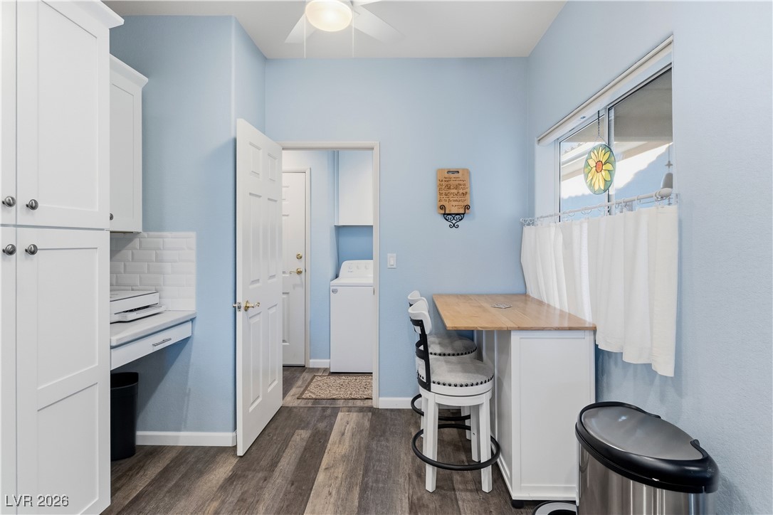 3350 Pheasant Canyon Way, Unit 1008 Laughlin, NV 89029 - Photo 18 of 80 Kitchen featuring white cabinetry, washer / clothes dryer, a kitchen bar, butcher block counters, and dark wood-style flooring