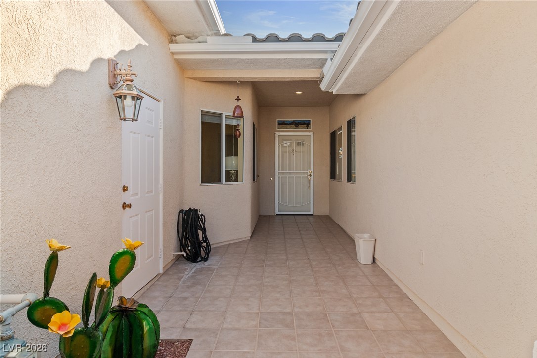 3350 Pheasant Canyon Way, Unit 1008 Laughlin, NV 89029 - Photo 3 of 80 Fabulous courtyard entry to property featuring stucco exterior and tiled floor