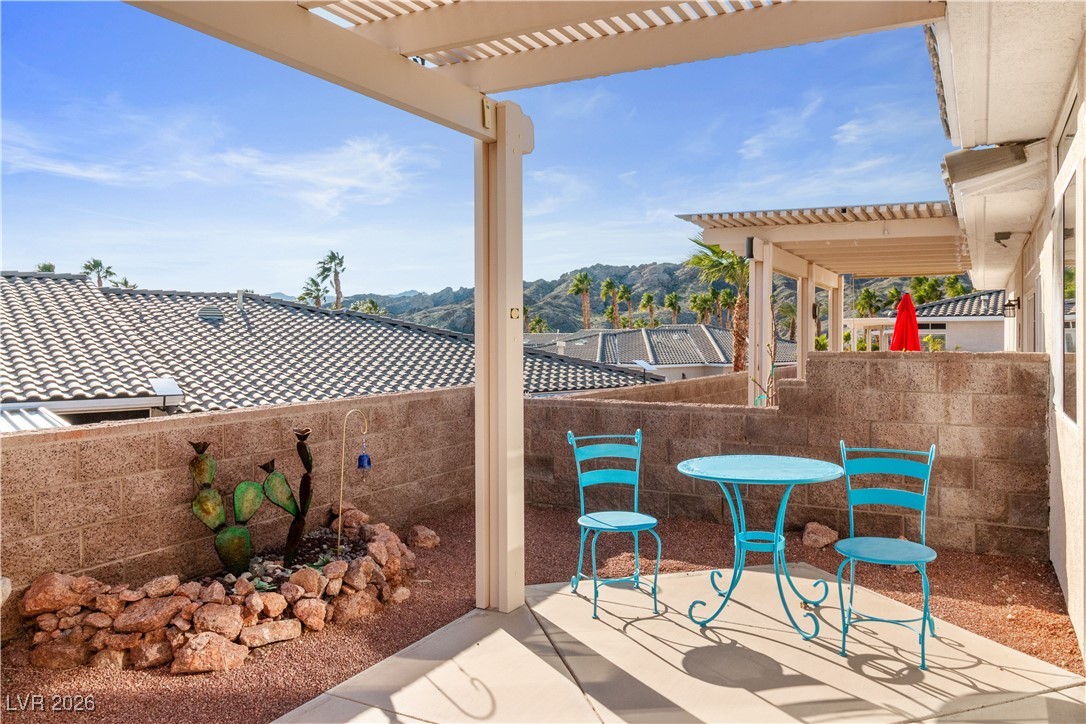 3350 Pheasant Canyon Way, Unit 1008 Laughlin, NV 89029 - Photo 50 of 80 Fenced backyard with a mountain view and a pergola
