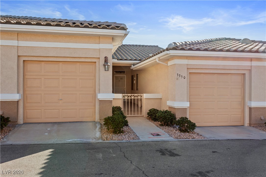3350 Pheasant Canyon Way, Unit 1008 Laughlin, NV 89029 - Photo 54 of 80 Mediterranean / spanish-style home with stucco siding, a tile roof, and a garage