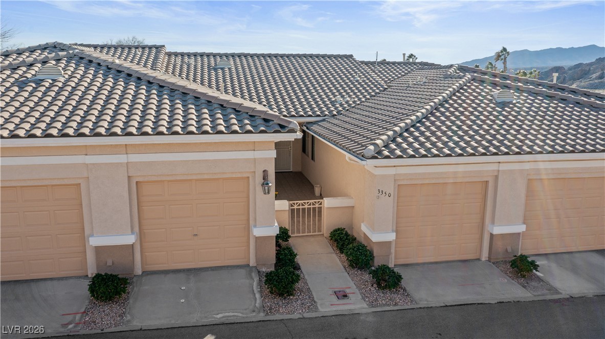 3350 Pheasant Canyon Way, Unit 1008 Laughlin, NV 89029 - Photo 69 of 80 Mediterranean / spanish-style home featuring stucco siding, a tiled roof, a gate, and a mountain view