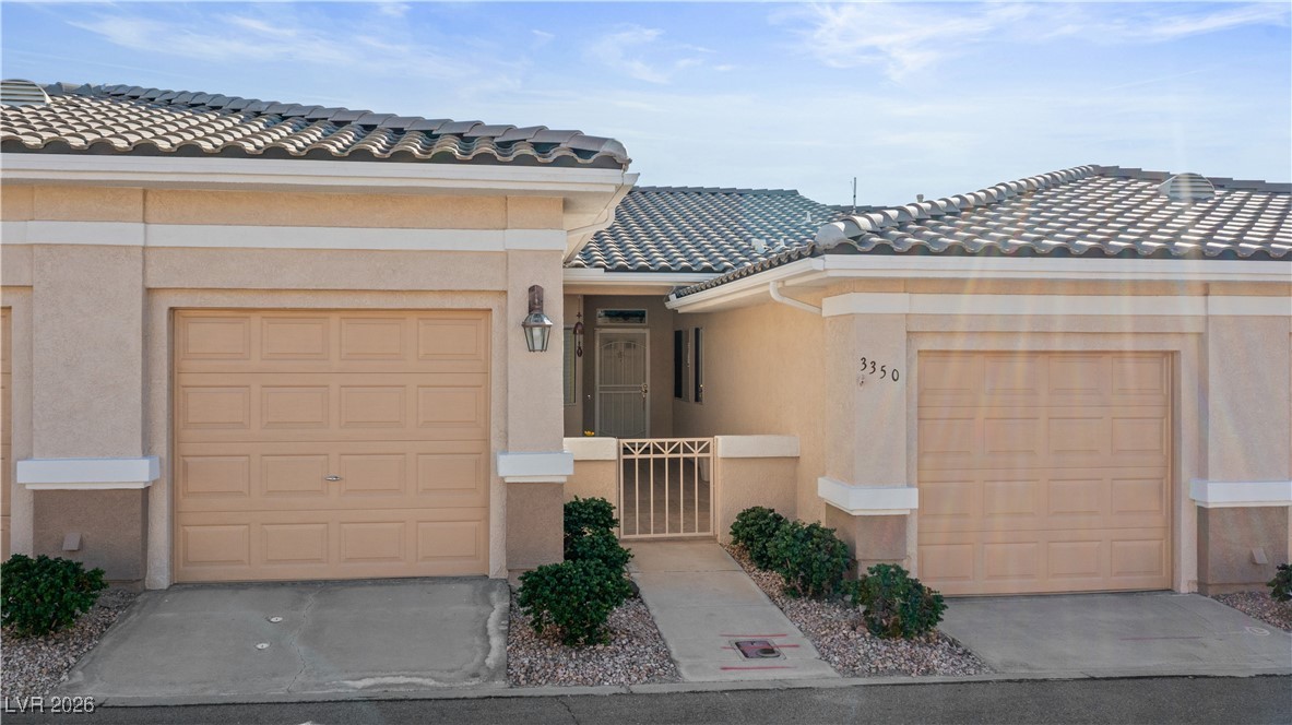 3350 Pheasant Canyon Way, Unit 1008 Laughlin, NV 89029 - Photo 72 of 80 View of front facade with stucco siding, a tile roof, and a garage
