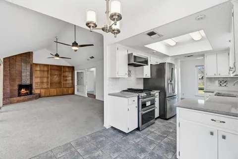a kitchen with stainless steel appliances granite countertop a stove and a refrigerator
