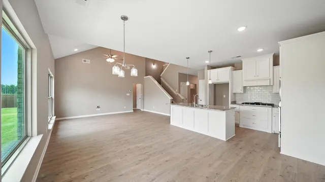 a view of kitchen with refrigerator and window