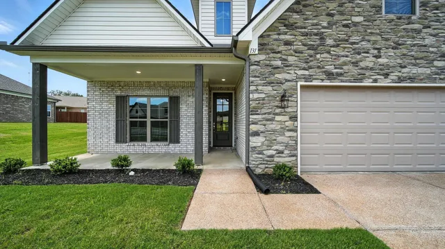 a front view of a house with garden