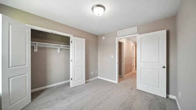 a view of an empty room and closet area