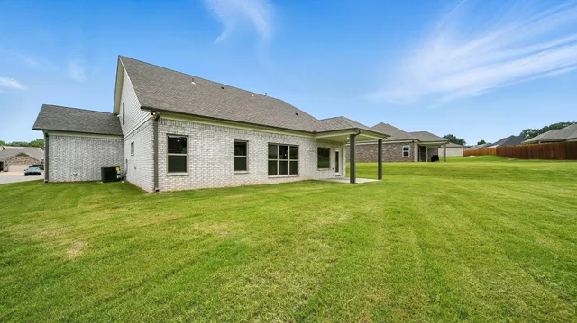 a view of a house with a backyard