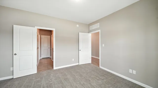 an empty room with closet area