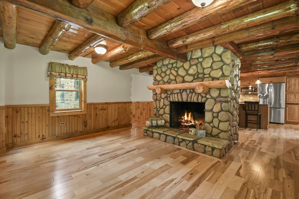 389 Kelly Road Northbridge, MA 01534 - Photo 12 of 40 a living room with stainless steel appliances kitchen island granite countertop furniture and a fireplace