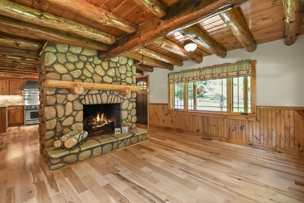 389 Kelly Road Northbridge, MA 01534 - Photo 14 of 40 a living room with stainless steel appliances wooden floors and fireplace