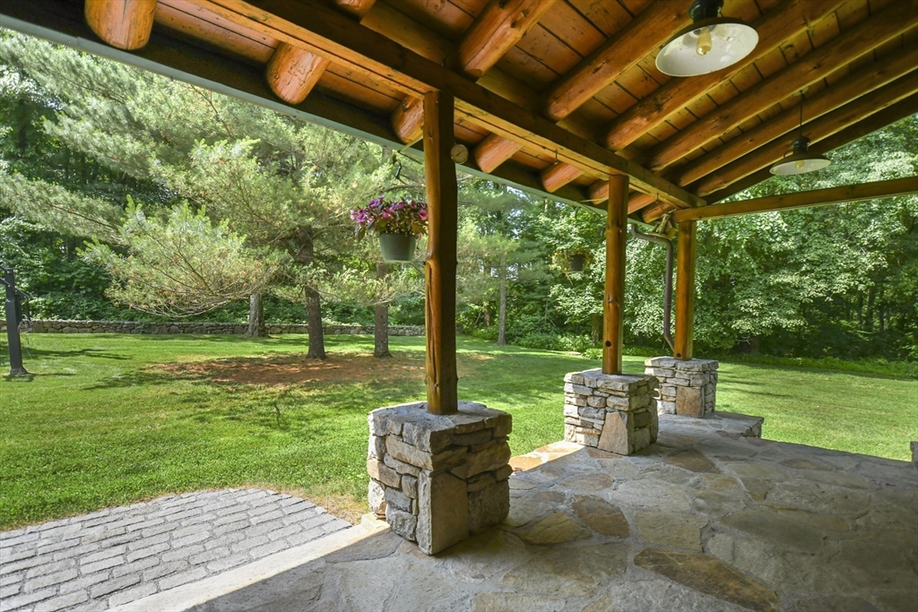 389 Kelly Road Northbridge, MA 01534 - Photo 35 of 40 a view of a patio with a table chairs and a backyard