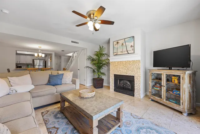 a view of a dining room with furniture and chandelier