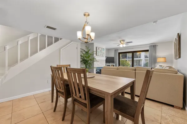 a view of a dining room with furniture and a chandelier