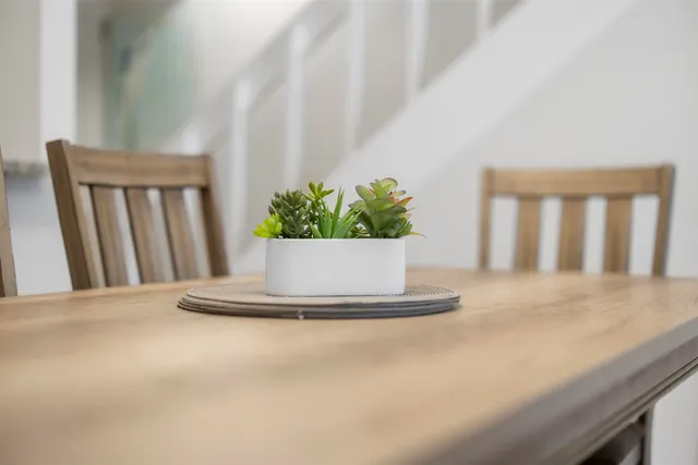 a dining room with a table and chairs