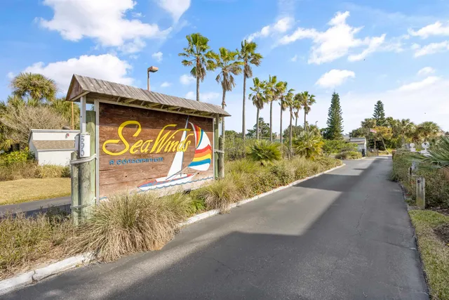 a street sign on a sidewalk next to a building
