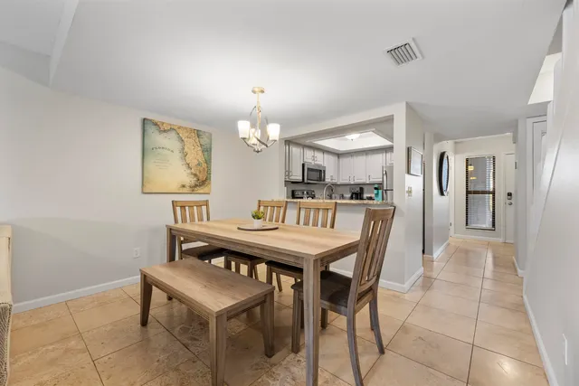 a kitchen with cabinets and chairs