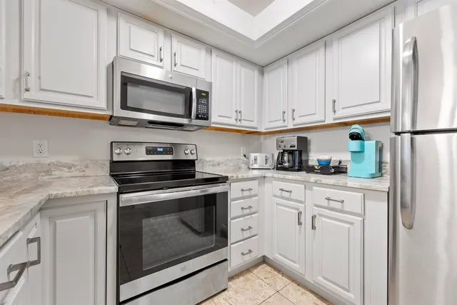 a kitchen with stainless steel appliances granite countertop a sink stove a microwave and cabinets