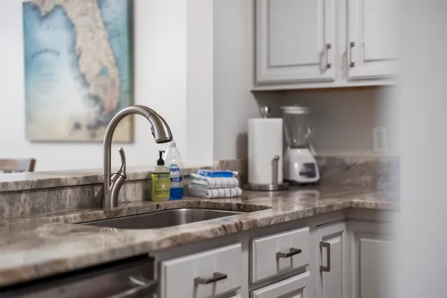 a view of a kitchen with sink and an oven