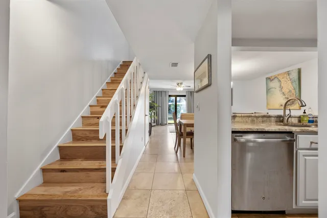 a bedroom with bed a tv and a ceiling fan