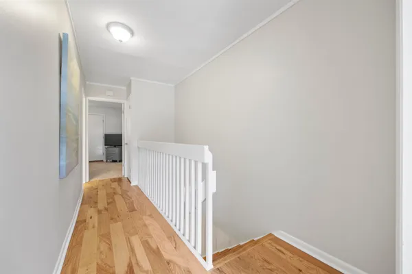 a bedroom with a bed and a flat tv screen on dresser