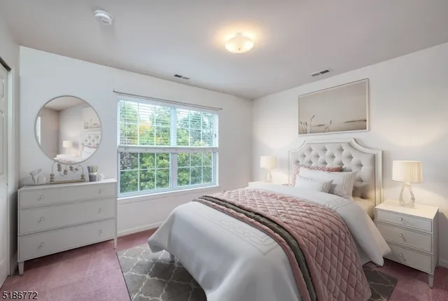 a bedroom with a bed and a large window