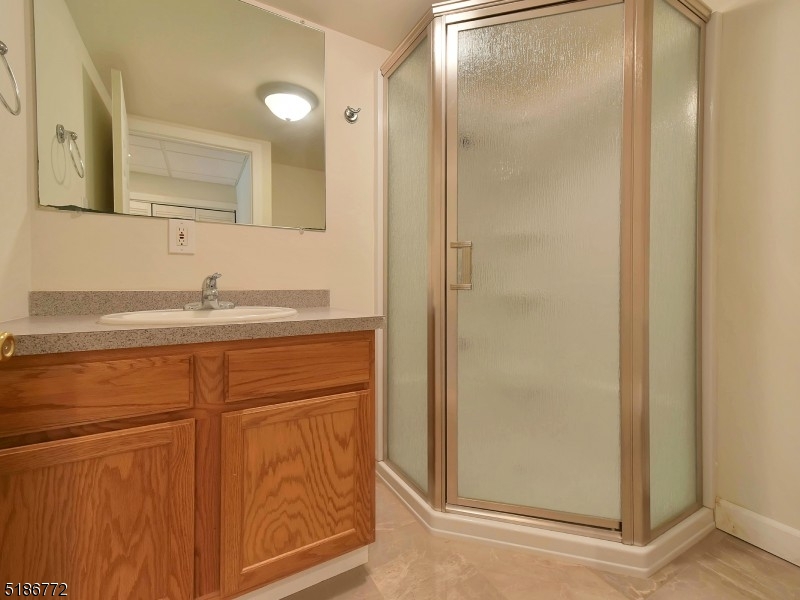 89 Hill Hollow Road Lake Hopatcong, NJ 07849 - Photo 22 of 25 a bathroom with a sink and a mirror