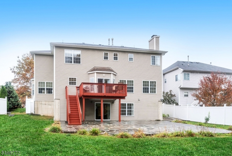 89 Hill Hollow Road Lake Hopatcong, NJ 07849 - Photo 25 of 25 a view of a white house with large windows and a yard