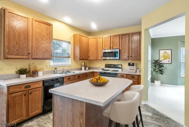 a kitchen with a sink a stove and chairs