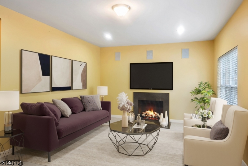 89 Hill Hollow Road Lake Hopatcong, NJ 07849 - Photo 10 of 25 a living room with furniture a fireplace and a flat screen tv