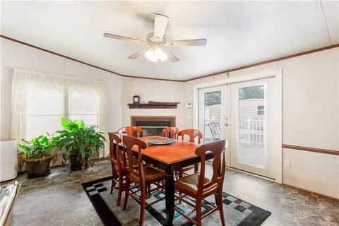 a dining room with furniture and potted plants