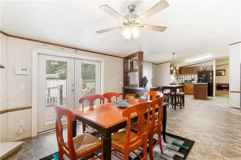 a view of a dining room with furniture and a chandelier