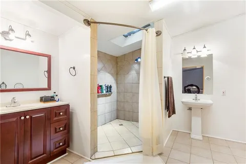 a bathroom with a sink mirror and toilet