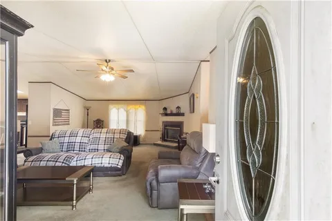 a living room with furniture and a chandelier