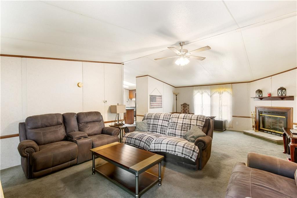 294 Birch Road Franklin, GA 30217 - Photo 3 of 30 a living room with furniture a fireplace and a chandelier
