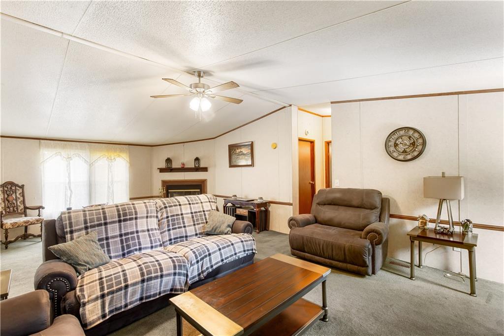 294 Birch Road Franklin, GA 30217 - Photo 4 of 30 a living room with furniture a clock on wall and a window