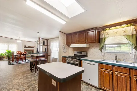 a kitchen with a table chairs sink and cabinets
